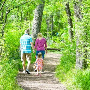 family walking through the woods
